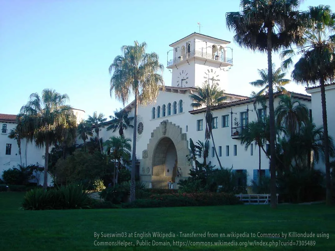 Spanish Colonial Revival clock tower and archway of the Santa Barbara County Courthouse framed by palm trees – plumber Montecito service area