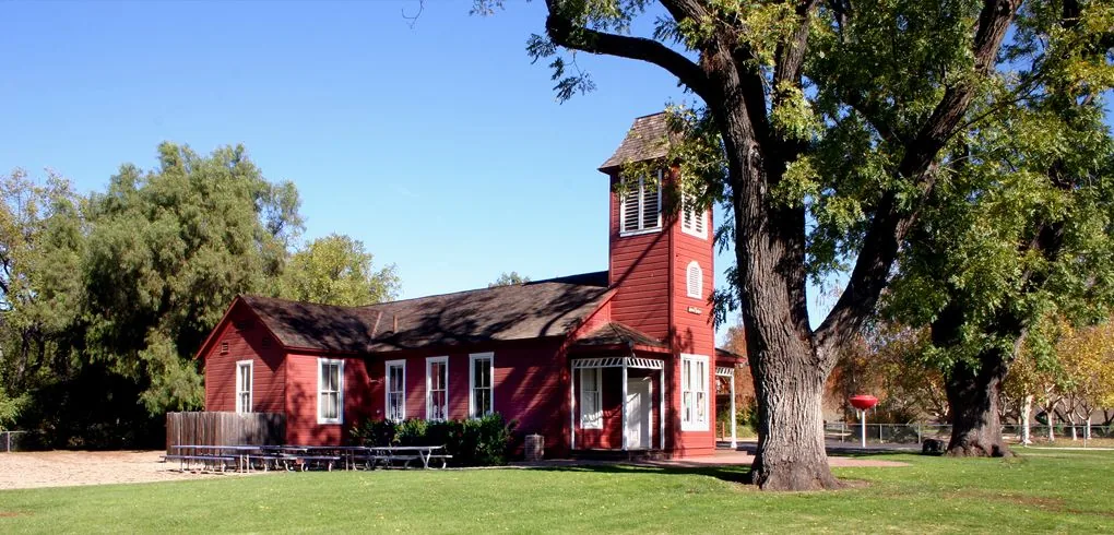 Historic Ballard Schoolhouse in Ballard, CA surrounded by green lawn and trees, service area for plumber in Ballard
