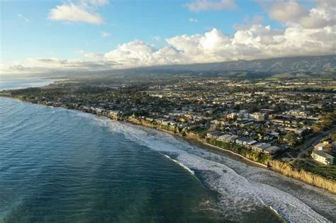 Aerial coastline of Isla Vista with surf and clifftop neighborhood, service area for Plumber in Isla Vista.