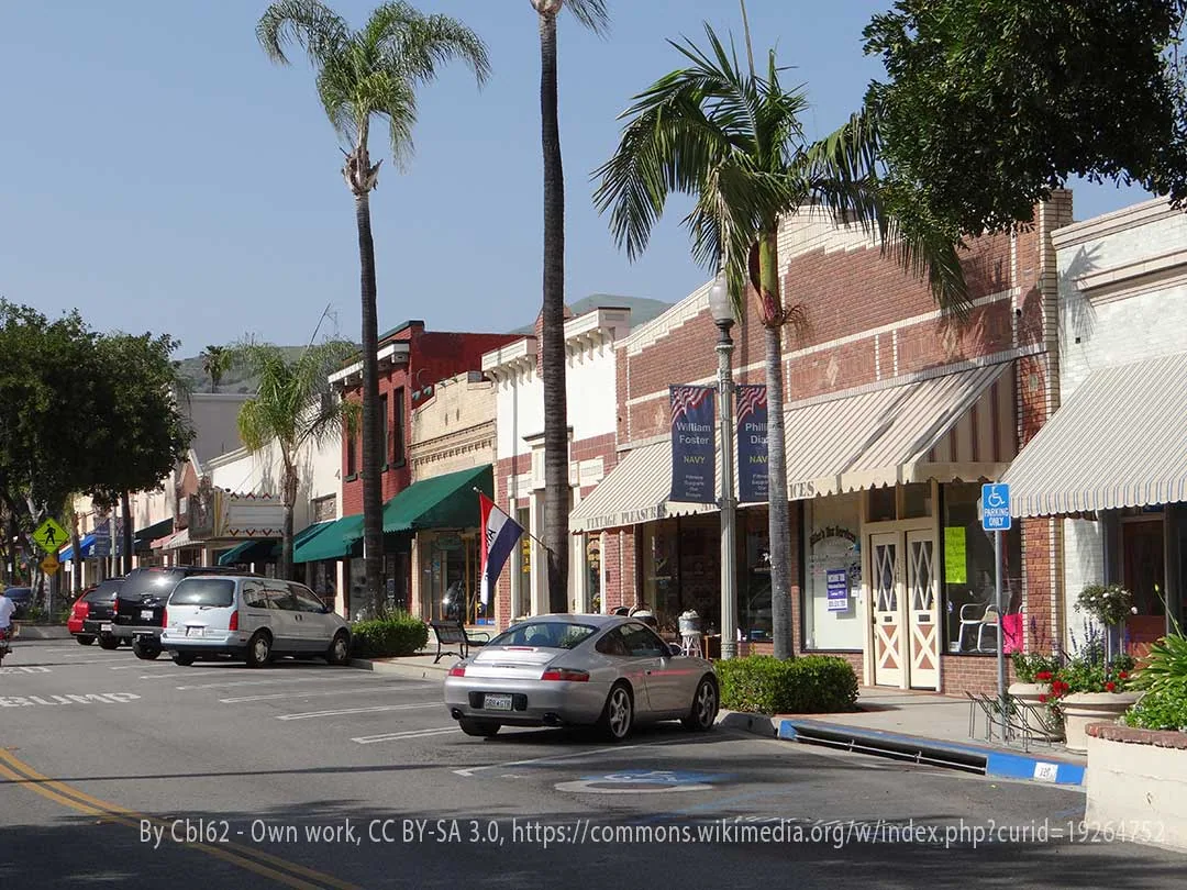 Historic downtown Fillmore, CA with brick storefronts, palm trees, and parked cars, service area for plumber in Fillmore