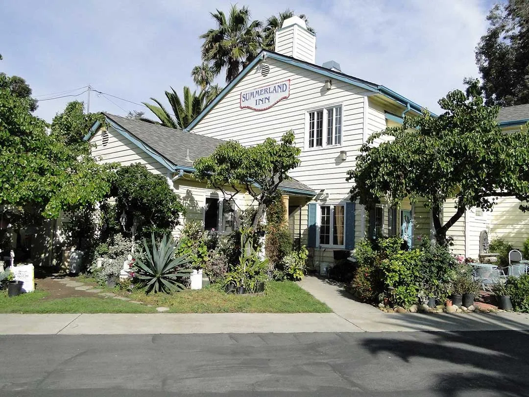 Exterior of Summerland Inn with lush trees and gardens, service area for Plumber in Summerland, CA.