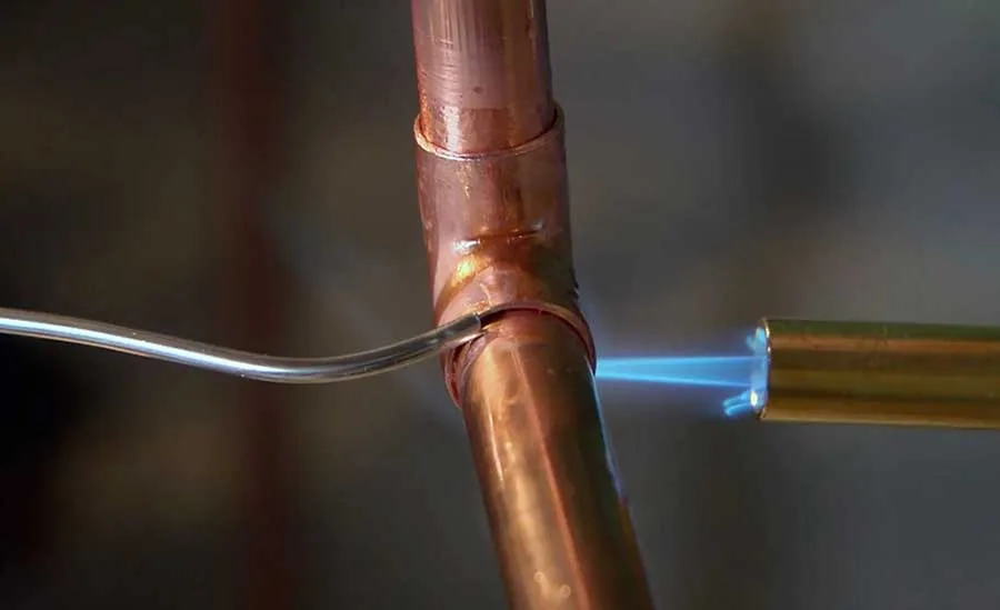 Water line repair in Ventura County showing plumber soldering copper pipes for Smart Choice Plumbing & Drains.