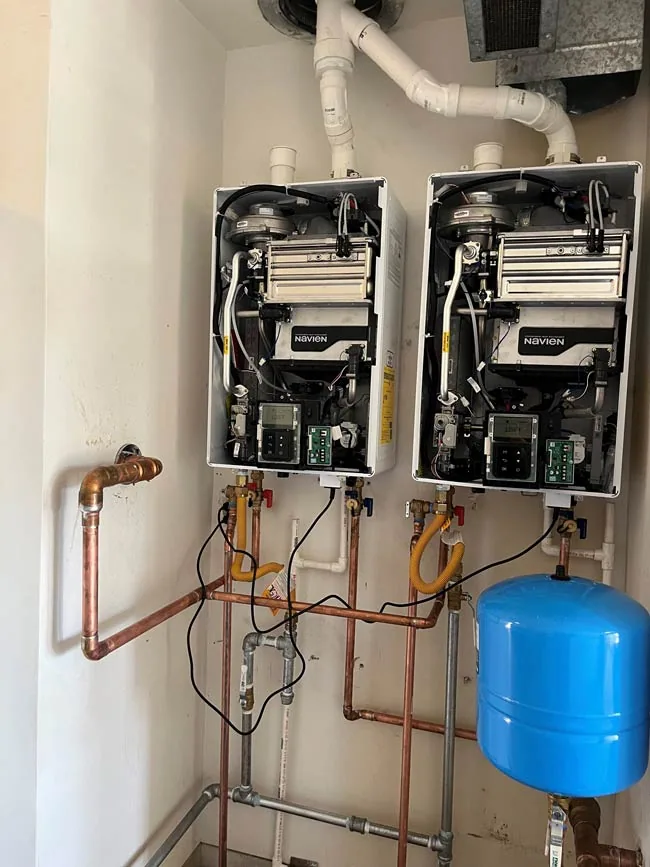 Dual Navien tankless water heaters installed by Smart Choice Plumbing with gas, water, and vent connections in Ventura and Santa Barbara.